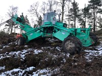 Large green construction vehicle, with a cable spool at the rear.