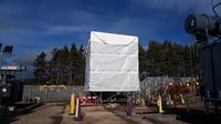 Wrapped scaffolding surrounded by substation infrastructure