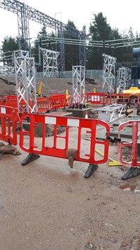 Metal substation infrastructure embedded in concrete blocks on a substation under construction.