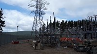 Scaffolding and construction supplies surrounding substation infrastructure.