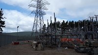 Scaffolding and construction supplies surrounding substation infrastructure.