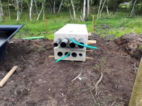 Black and green cylinders embedded in concrete sections.