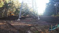 The base of a metal transmission tower.