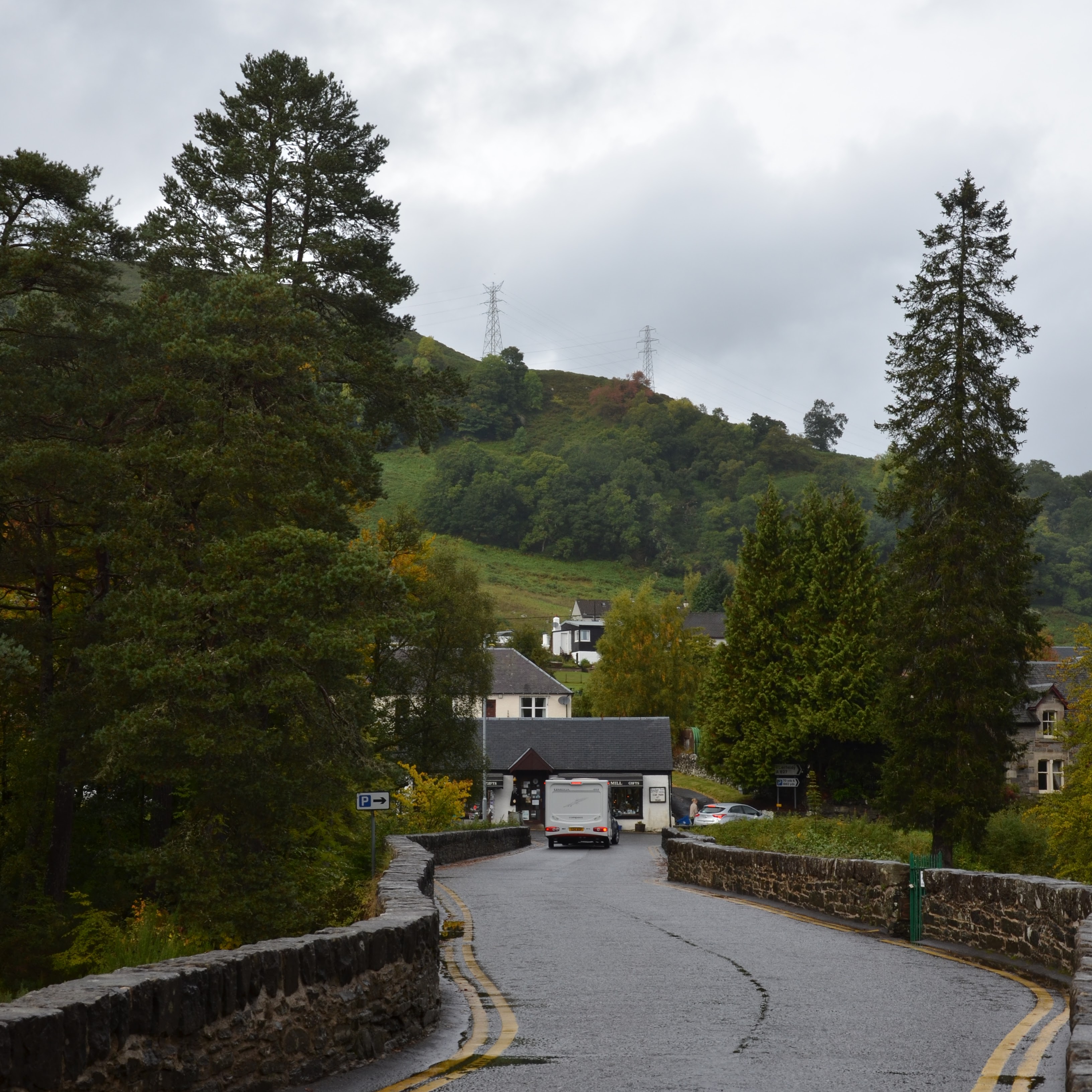 A road bordered by stone walls.