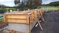 A concrete section secured by wooden supports.