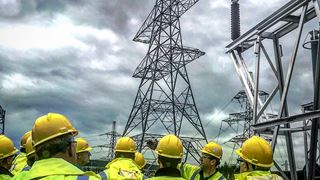 Engineers with powerlines in the background