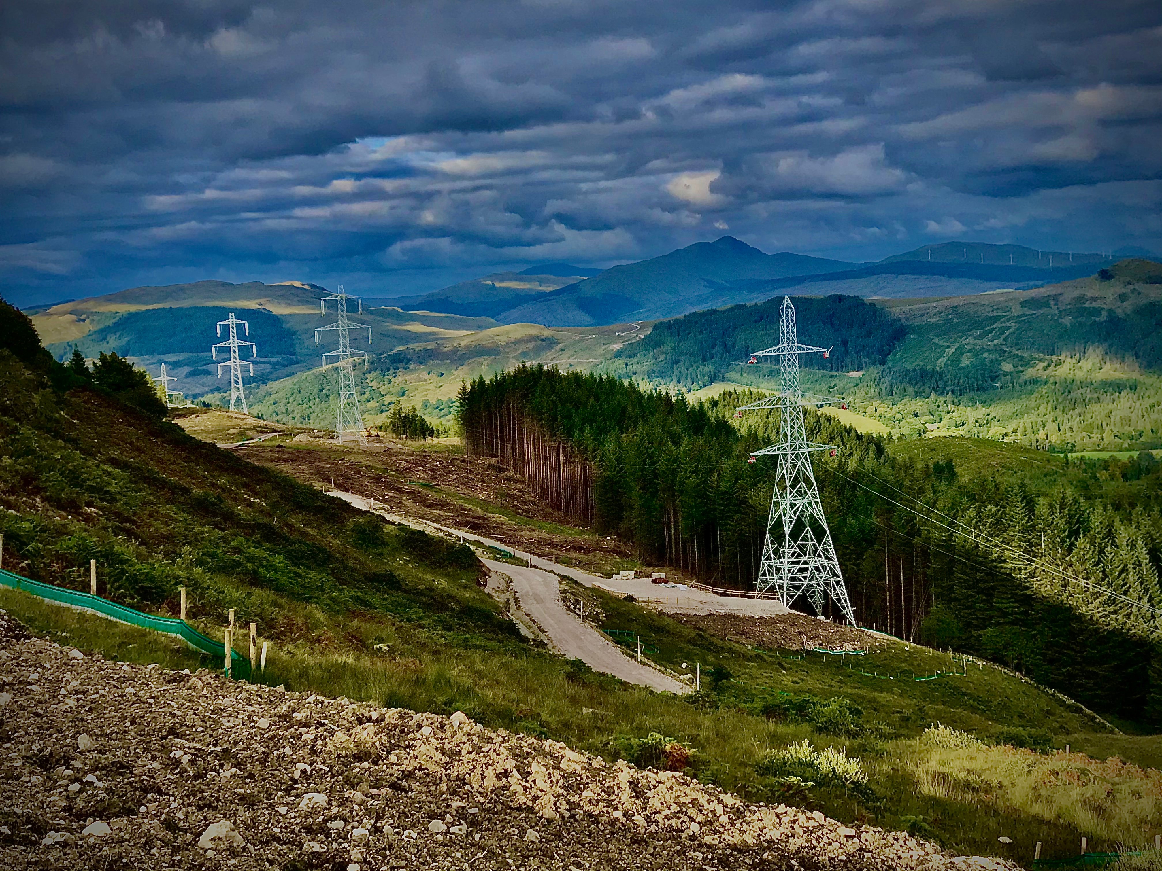 Country landscape with four transmission towers visible