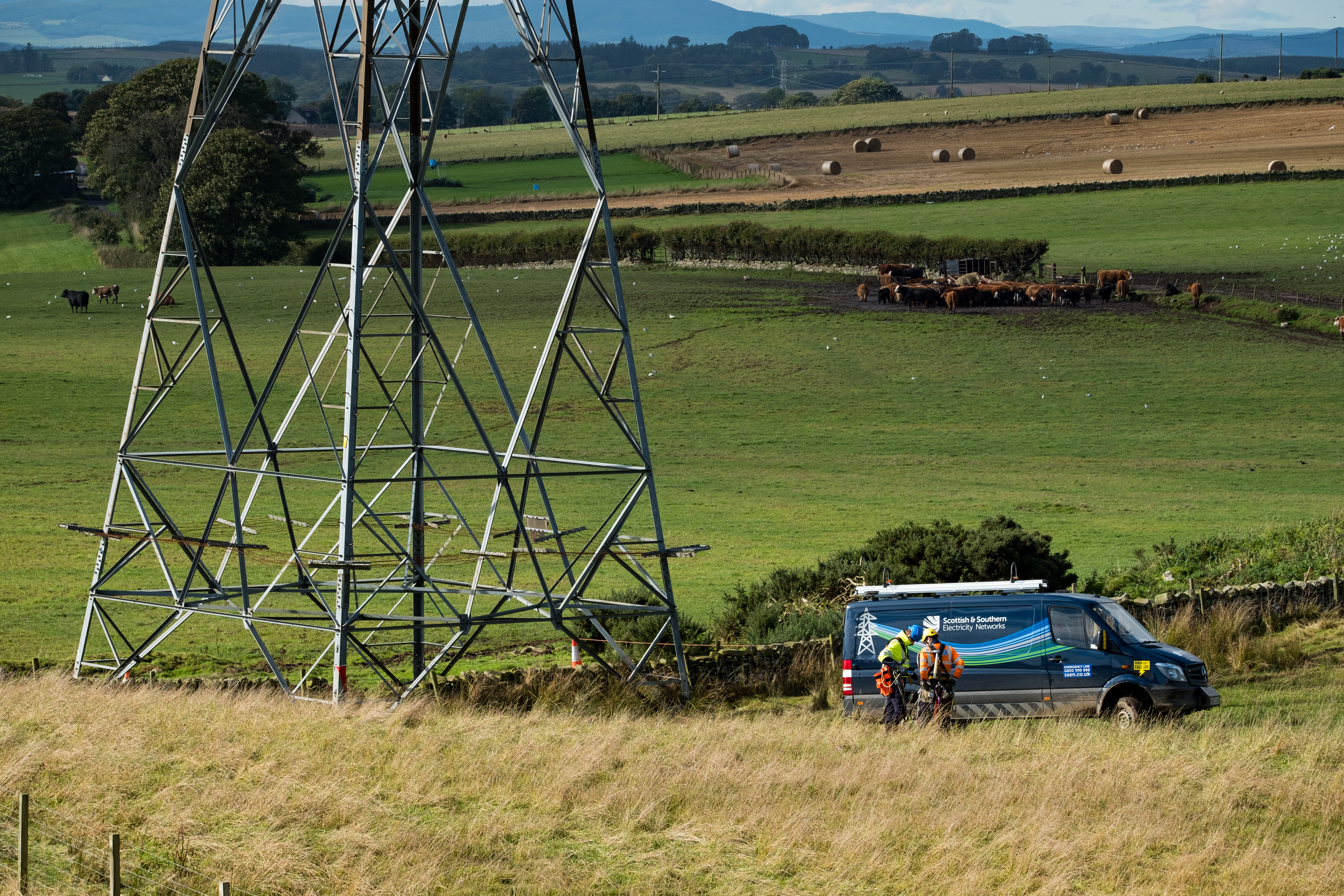 ssen transmission vehicle below steel lattice tower.