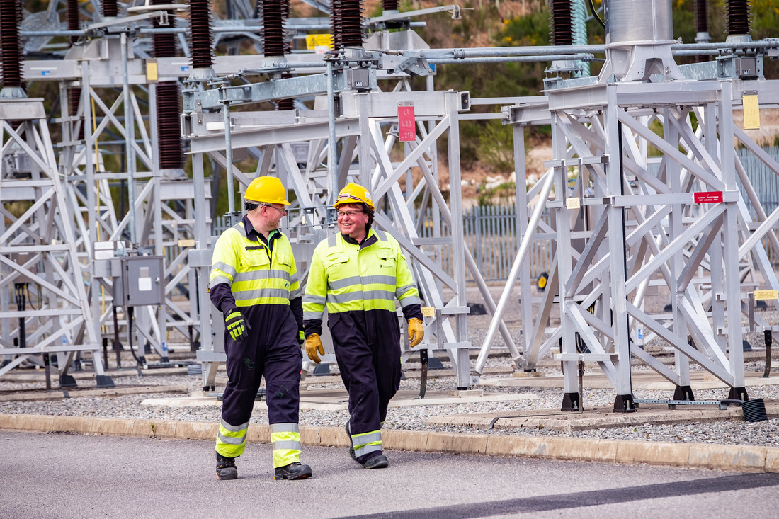 Fort Augustus Substation Colleagues Image of two SSEN Transmission employees walking in a substation