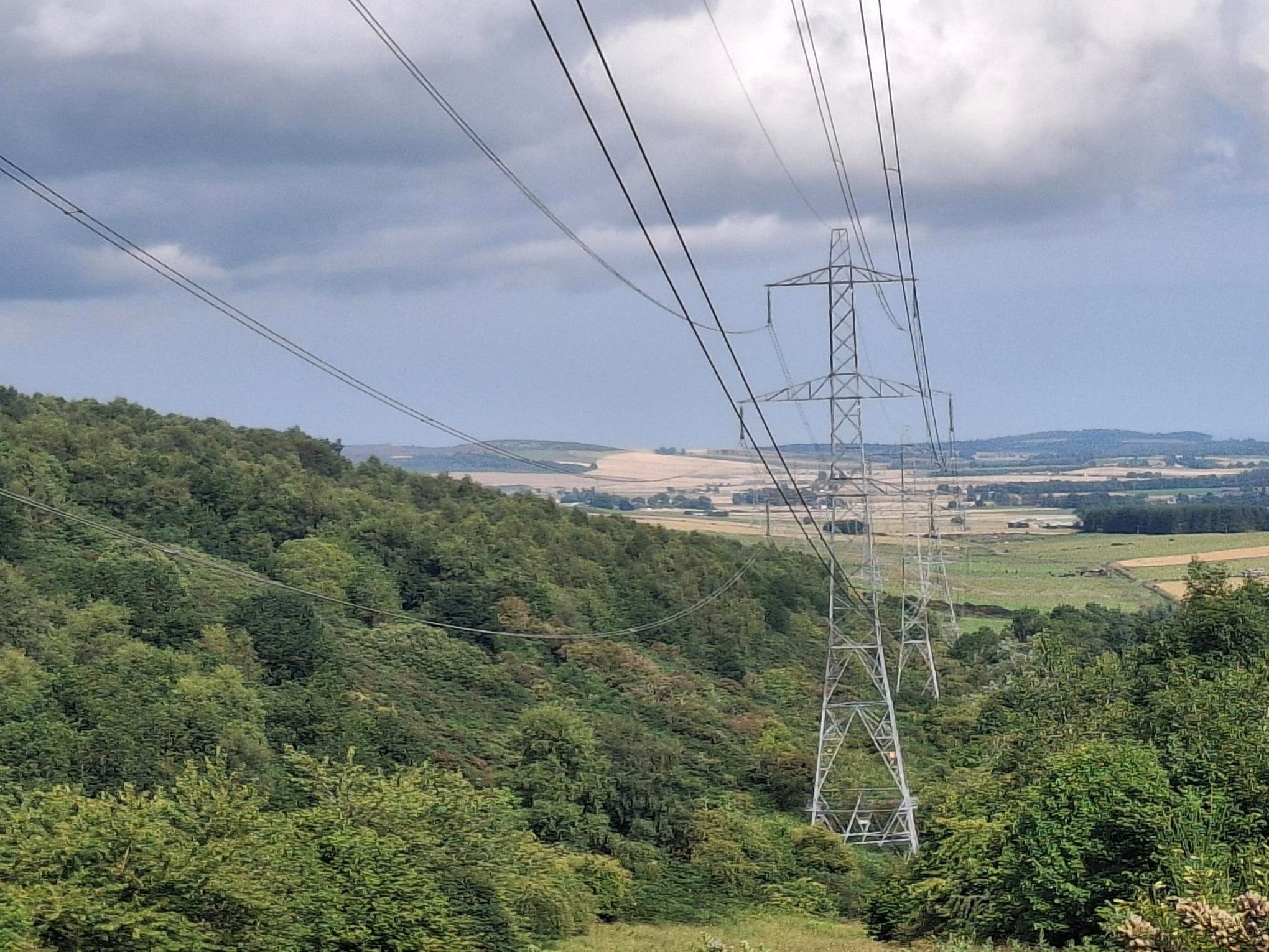 Image shows Alyth to Tealing Overhead Line Transmission infrastructure of lattice towers connect by electrical cabling