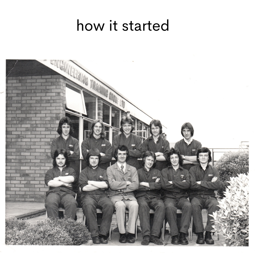 Black and white photo of eleven men in front of an engineering training school with superimposed text reading "how it started" above 