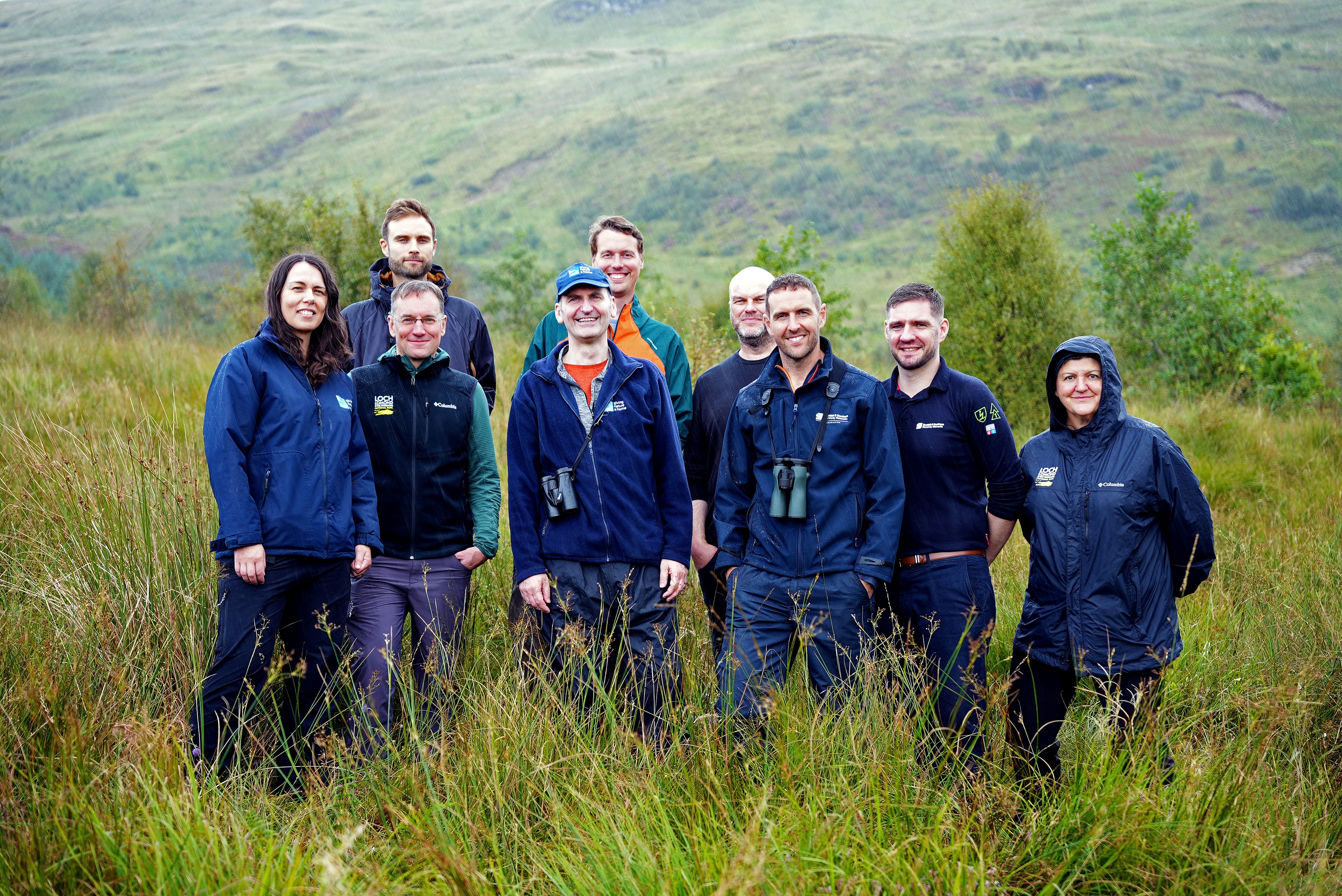 Image shows members of RSPB Scotland, Loch Lomond & The Trossachs National Park and SSEN Transmission at the Inversnaid Reserve.